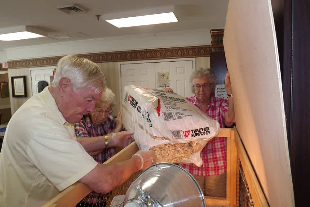 Max Eubanks, Blanche Eilert and Donna King, Morning Pointe of Franklin residents, love to lend a helping hand tending to our chickens. Their bedding is changed on a regular basis as well as the water and food.
