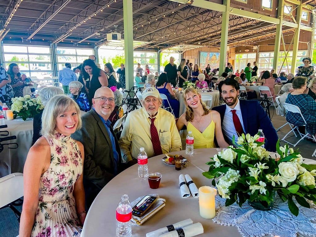 photo of Mike Thomas, center, and his family - granddaughter Sarah Freed and her husband on the right