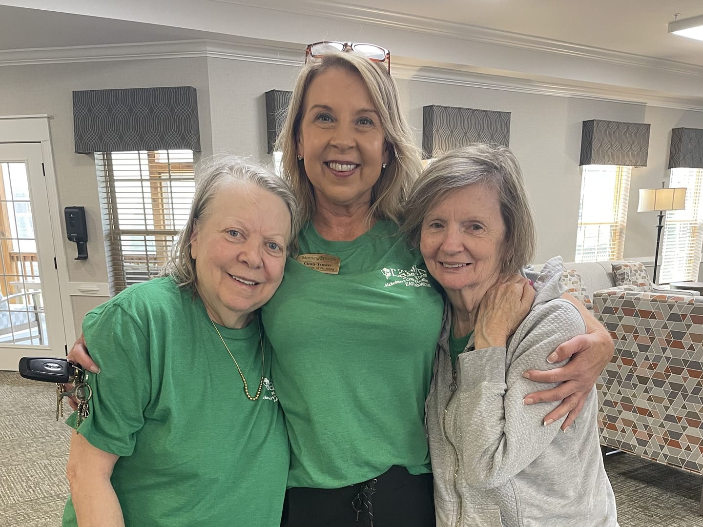 photo of Director of Nursing Cindy Tucker with two residents
