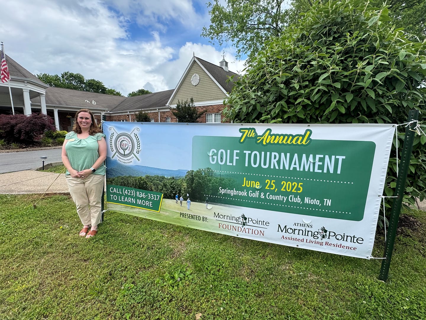 photo of Crystal Sutton, Morning Pointe of Athens executive director, with the Golf Tournament banner