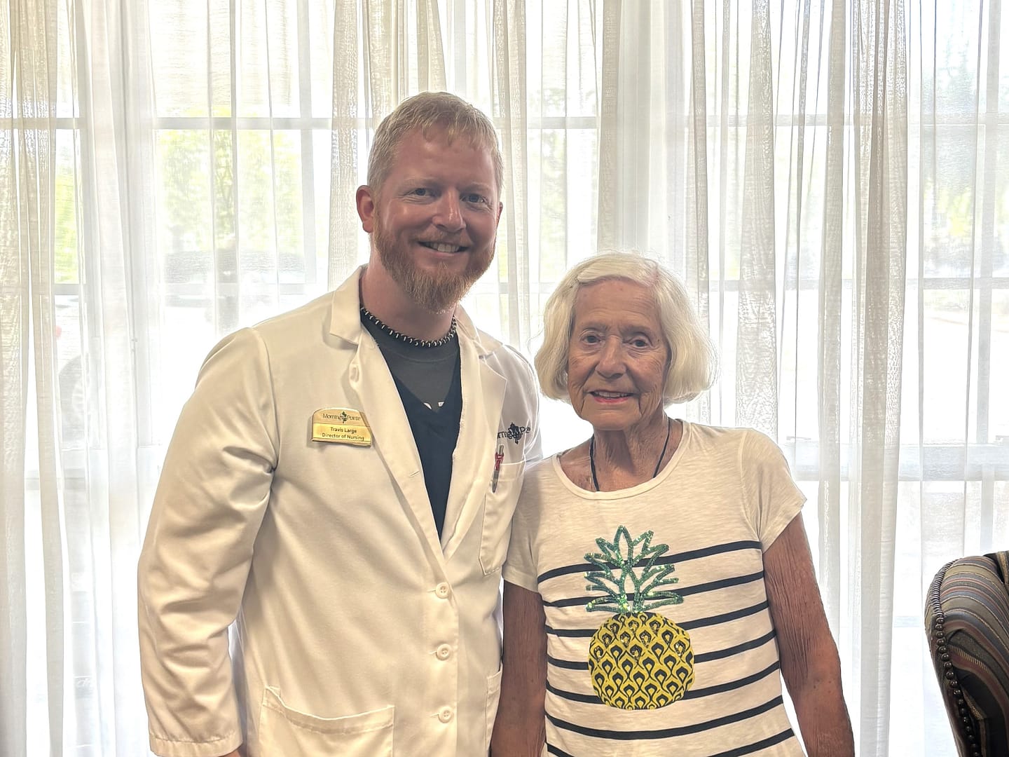 photo of Travis Large, DON, with resident "Bertie" Waggoner