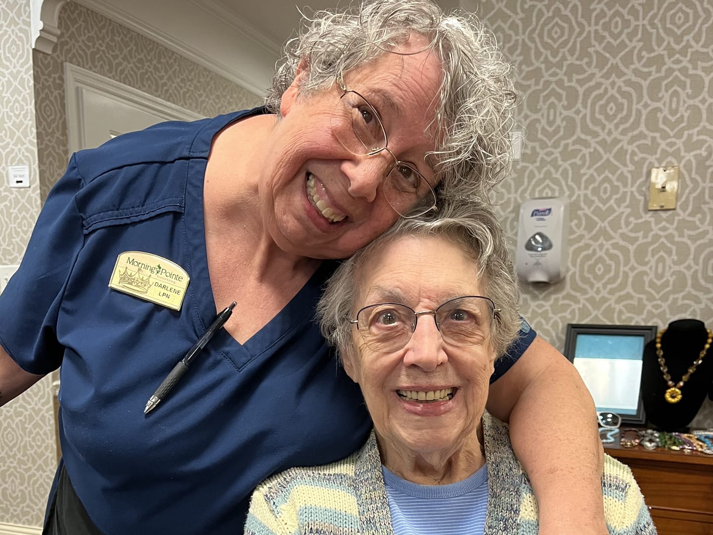 photo of Darlene Pope hugging resident Helen Stagnero