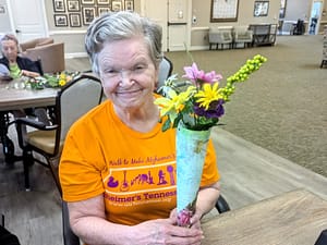 horizontal photo of Hardin Valley Lantern resident with flowers