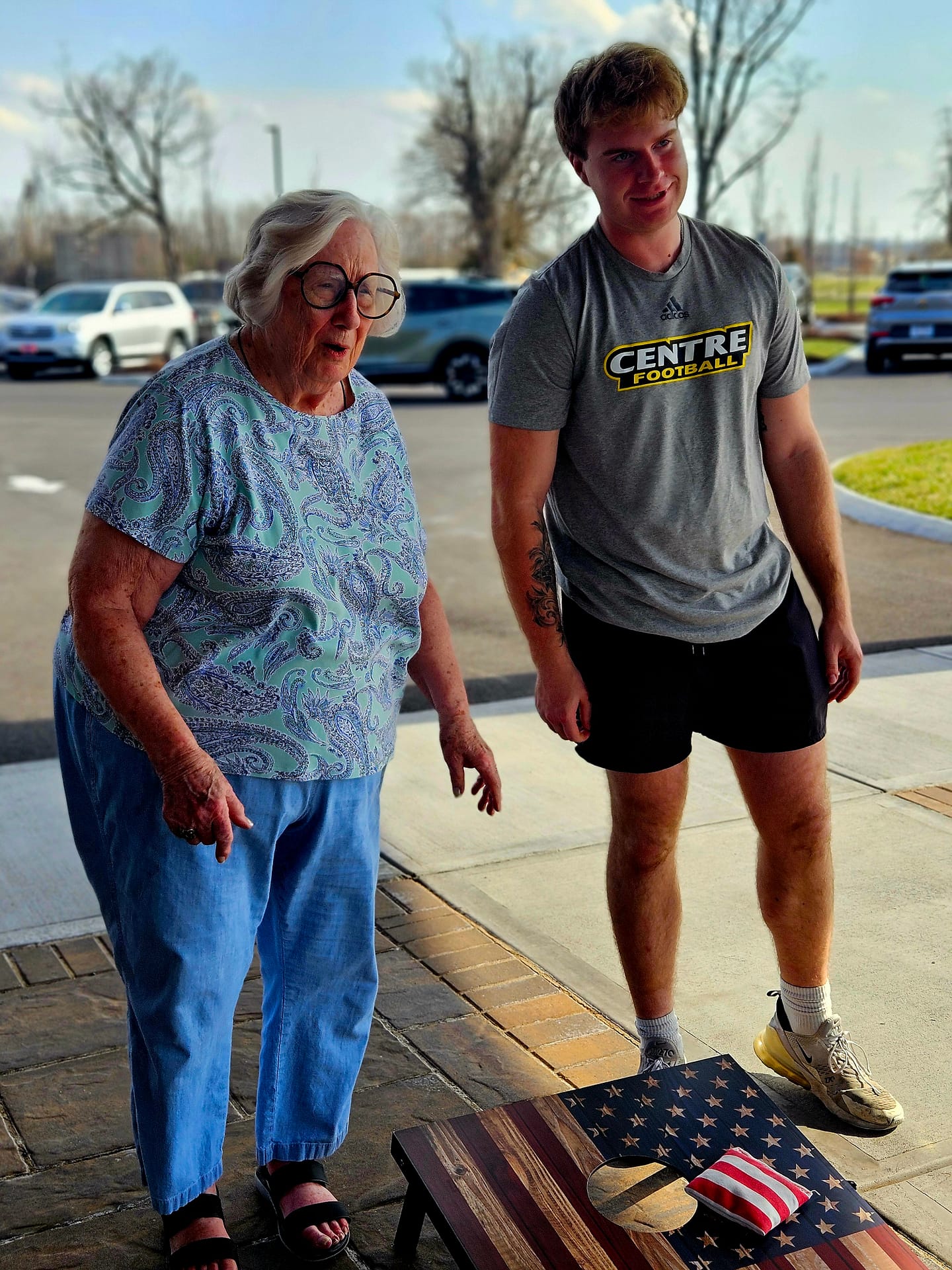 photo of Jackie playing cornhole with a Centre College student