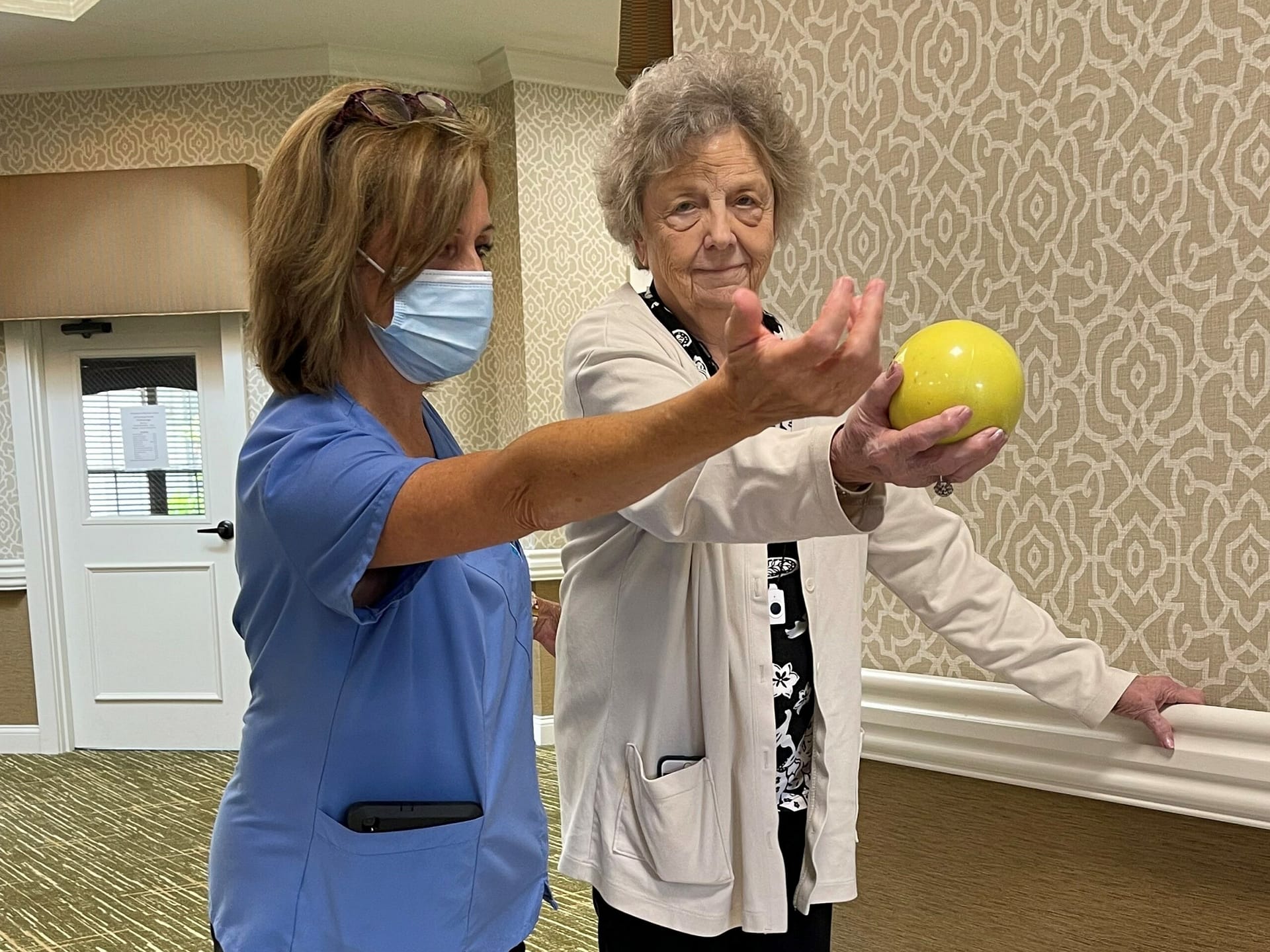 photo of therapist working with resident in gym