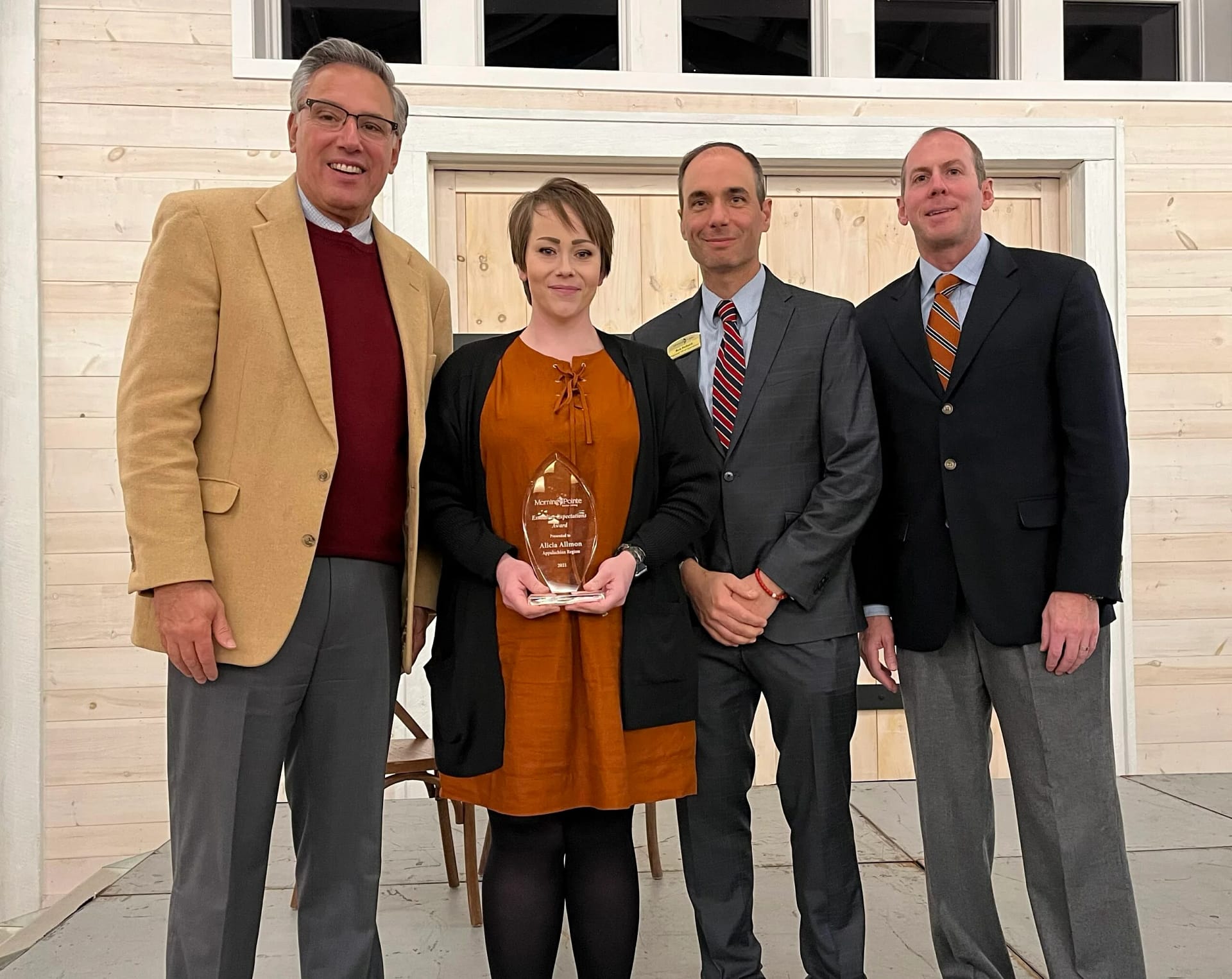 Group photo with Alicia Allmon holding exceeding expectations award