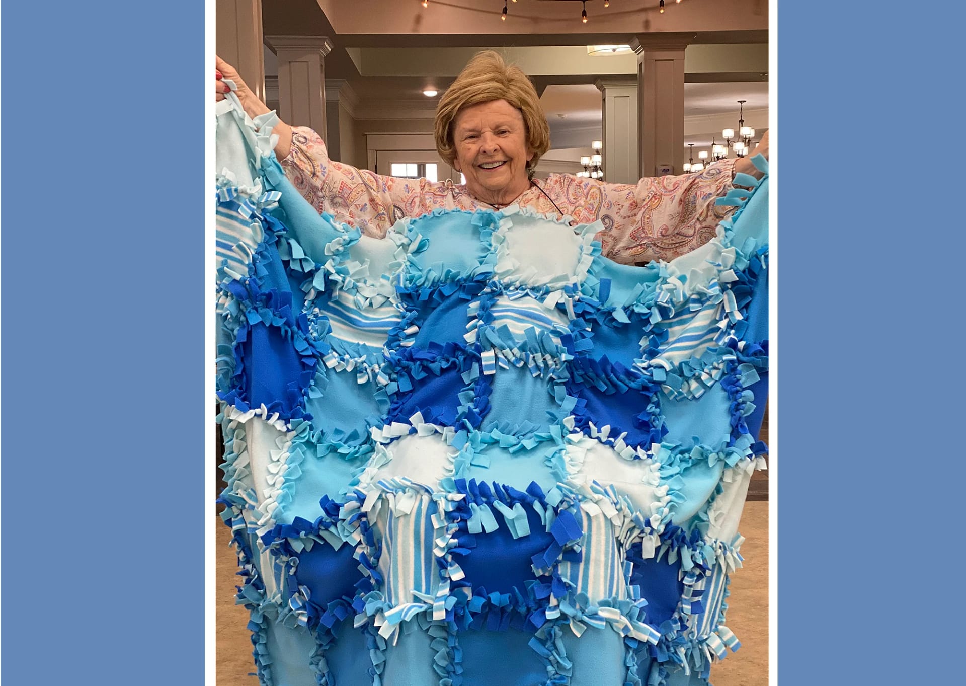 Senior lady showing off homemade blanket for Erlanger Children's Hospital