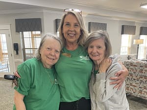 photo of Director of Nursing Cindy Tucker with two residents