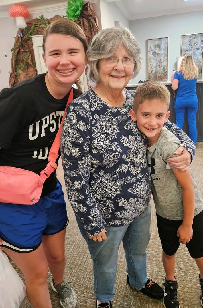 photo of Lynne with two of her grandchildren