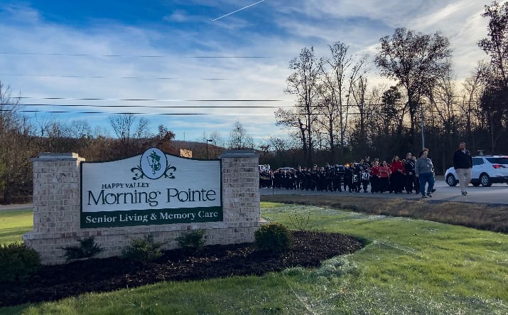 photo of the Ridgeland High School marching band and the Morning Pointe at Happy Valley sign