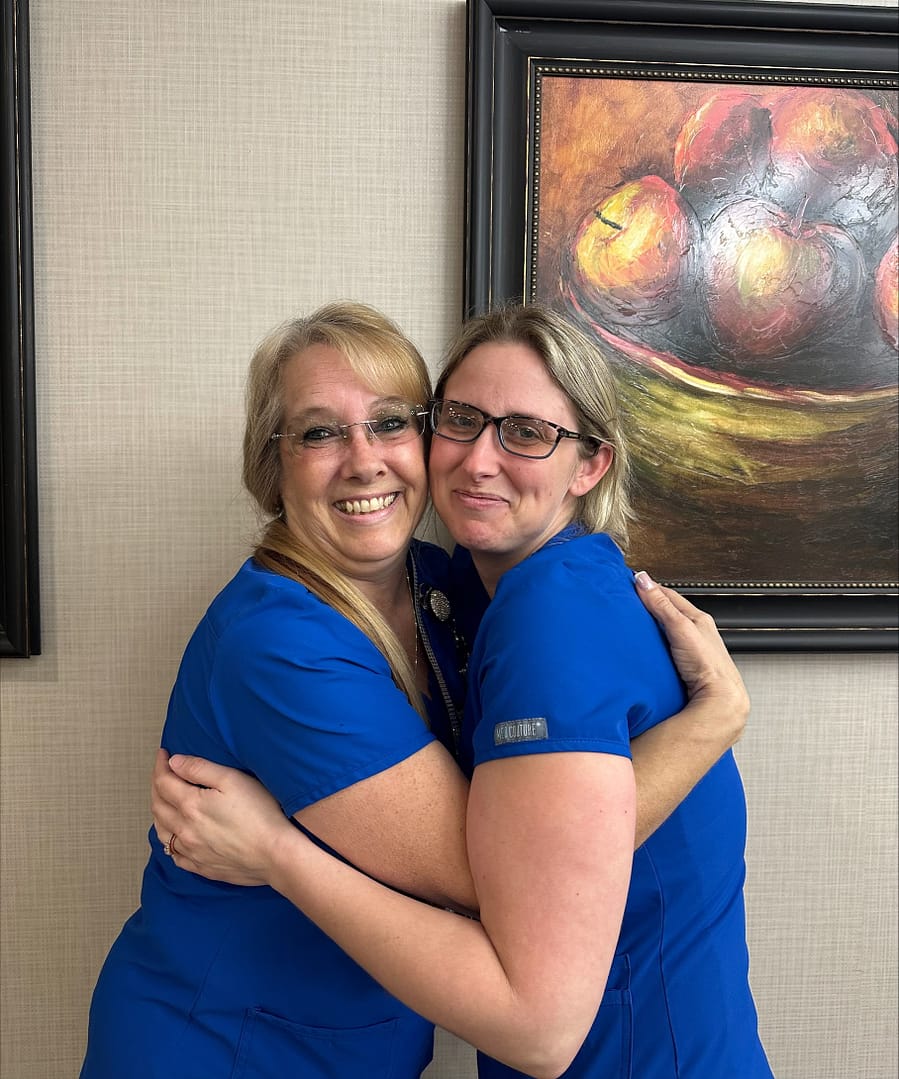 photo: Karen Westbrook, RA (left), and Amber Shirley, CNA (right) enjoy working together to brighten the residents’ days.