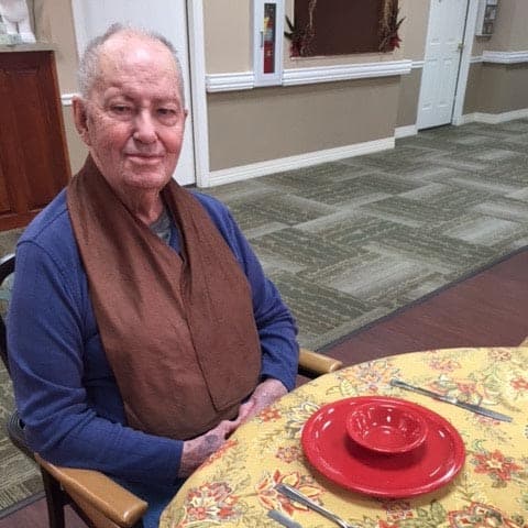 senior man at Morning Pointe Senior Living sitting at a dining table