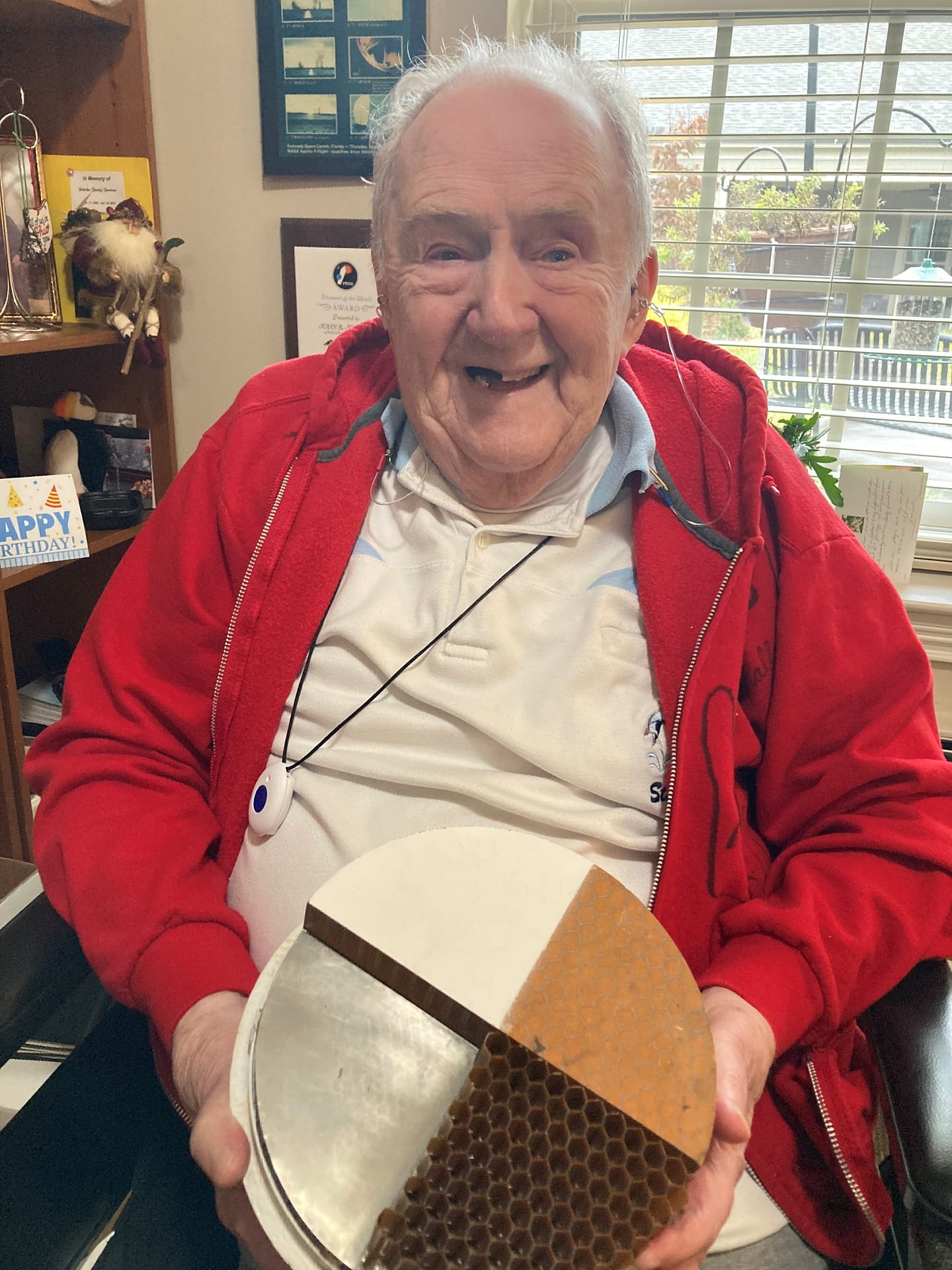 photo of John Johnson with a model of the honeycomb structure for the space capsule heat shield