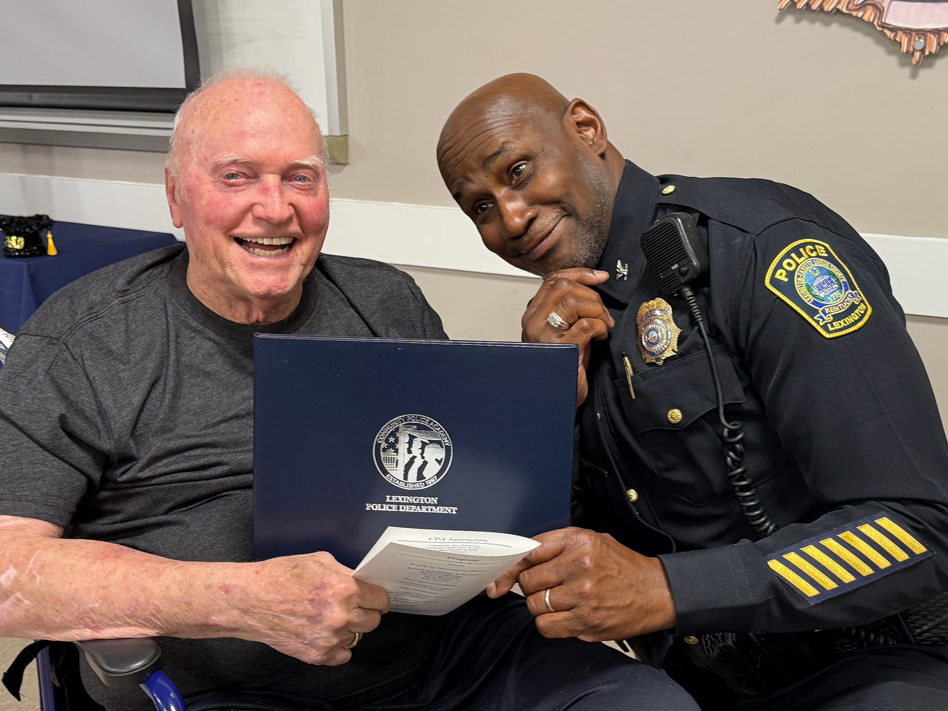 Photo of Resident Tony Patterson receiving his certificate from Lexington Police Chief Lawrence Weathers