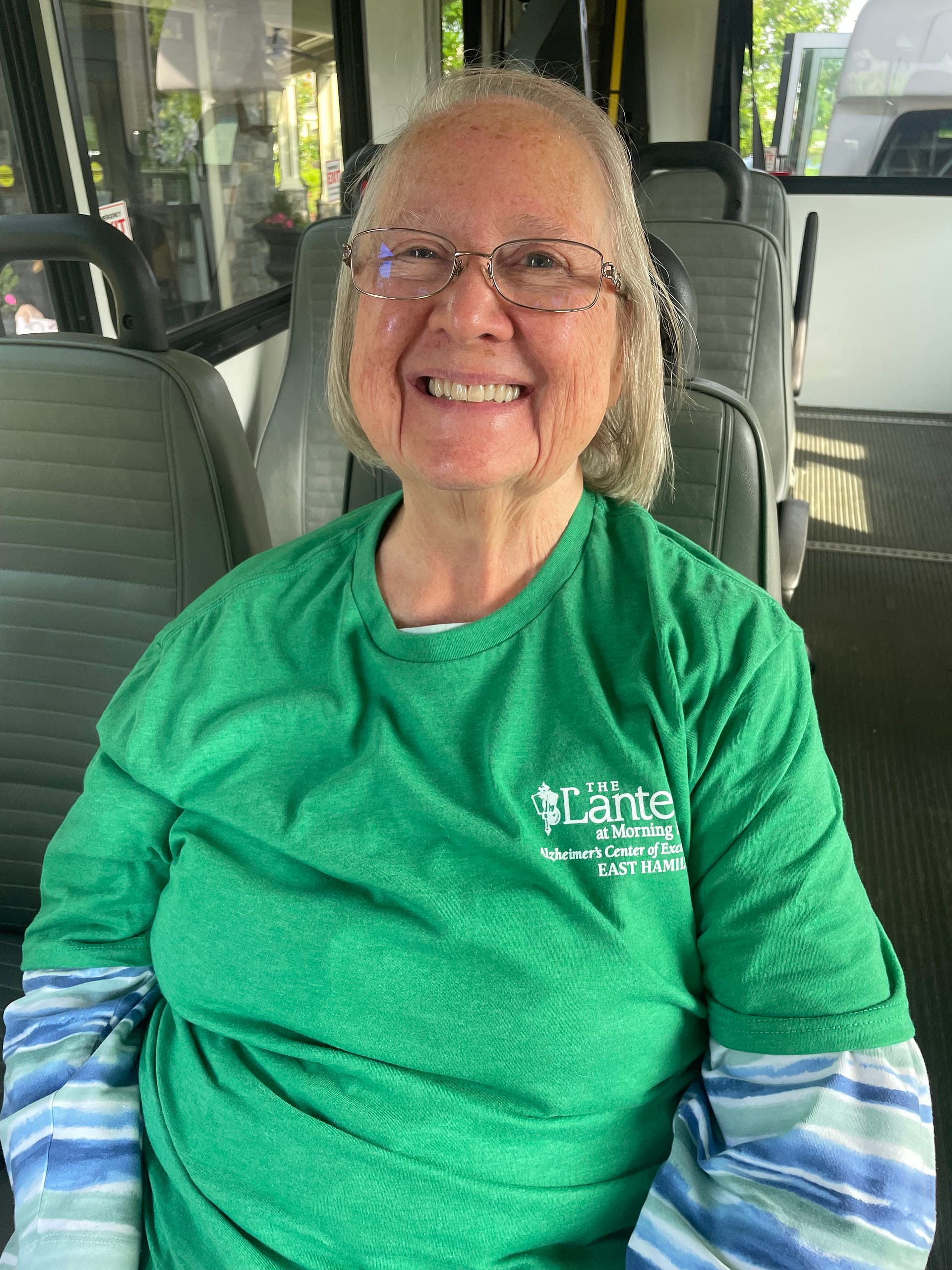 photo of a resident giving a big smile on the bus