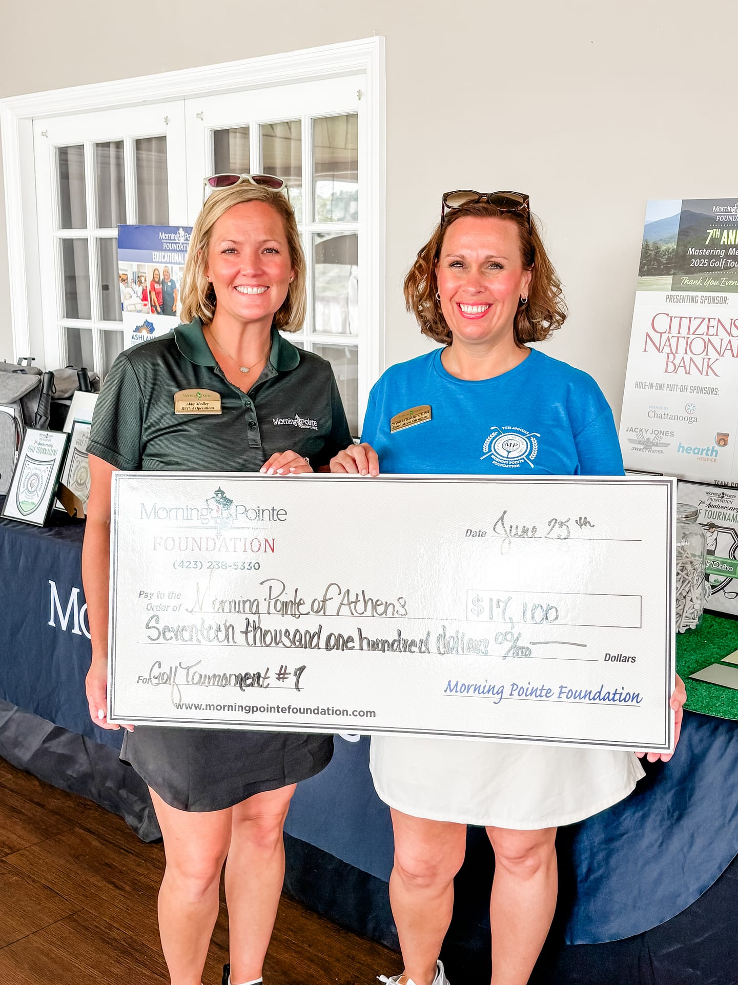 photo of Abby Medley, Morning Pointe Senior Living RVP of Operation, and Crystal Sutton, executive director at Morning Pointe of Athens, with the amount raised for the Morning Pointe Foundation at the Athens Golf Tournament