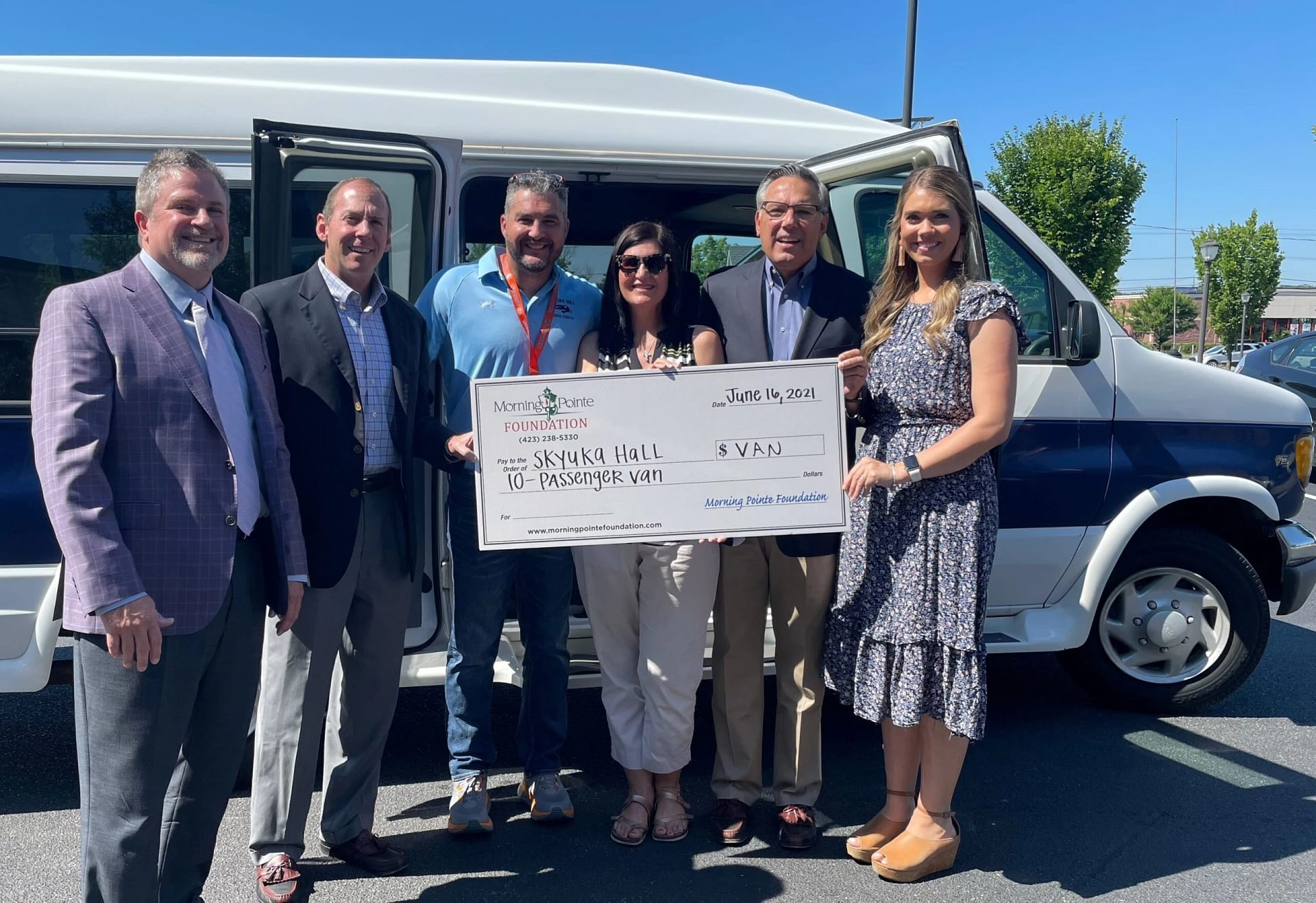 Group photo with donation of a van being presented