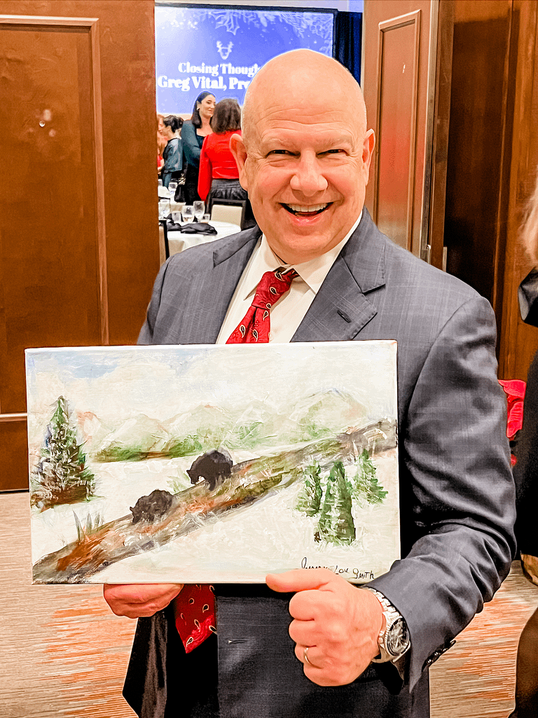 photo of Doug Brown, Senior Vice President - Wealth Management The Union Square Group, with JimmyeLou Smith's painting