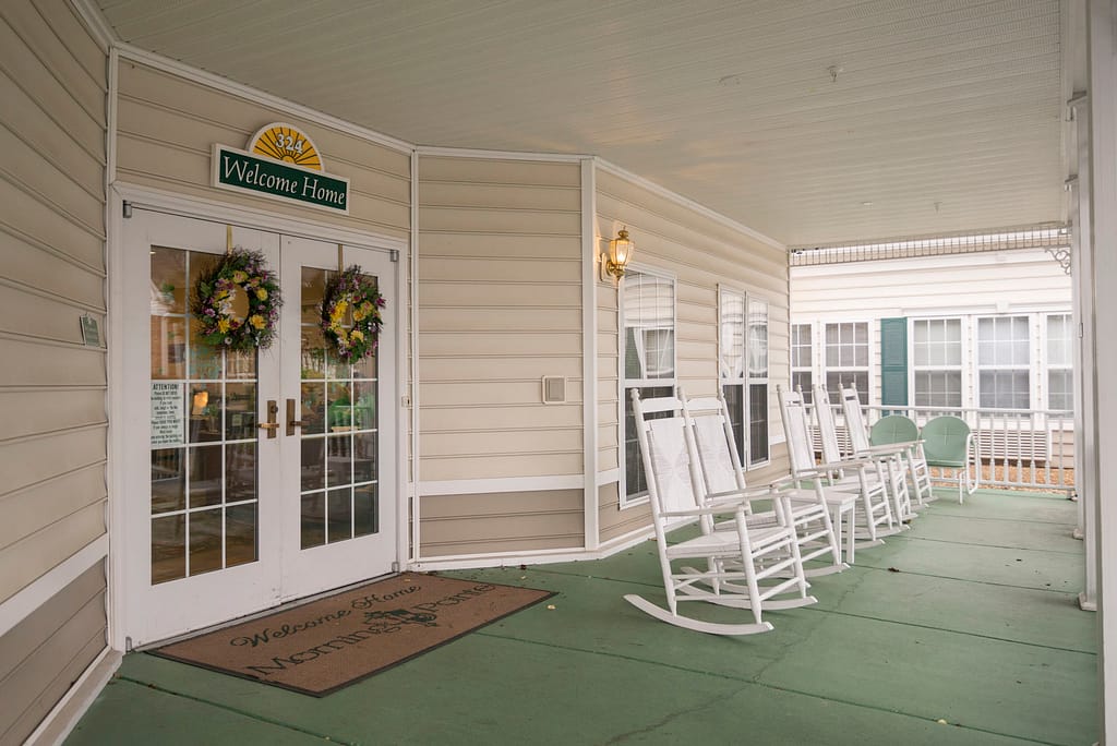 Greeneville campus front porch lined with rocking chairs