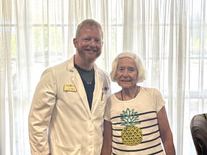 photo of Travis Large, DON, with resident "Bertie" Waggoner