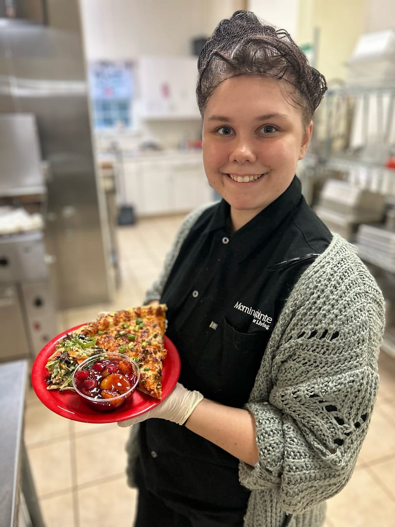 photo of cook holding plate of food