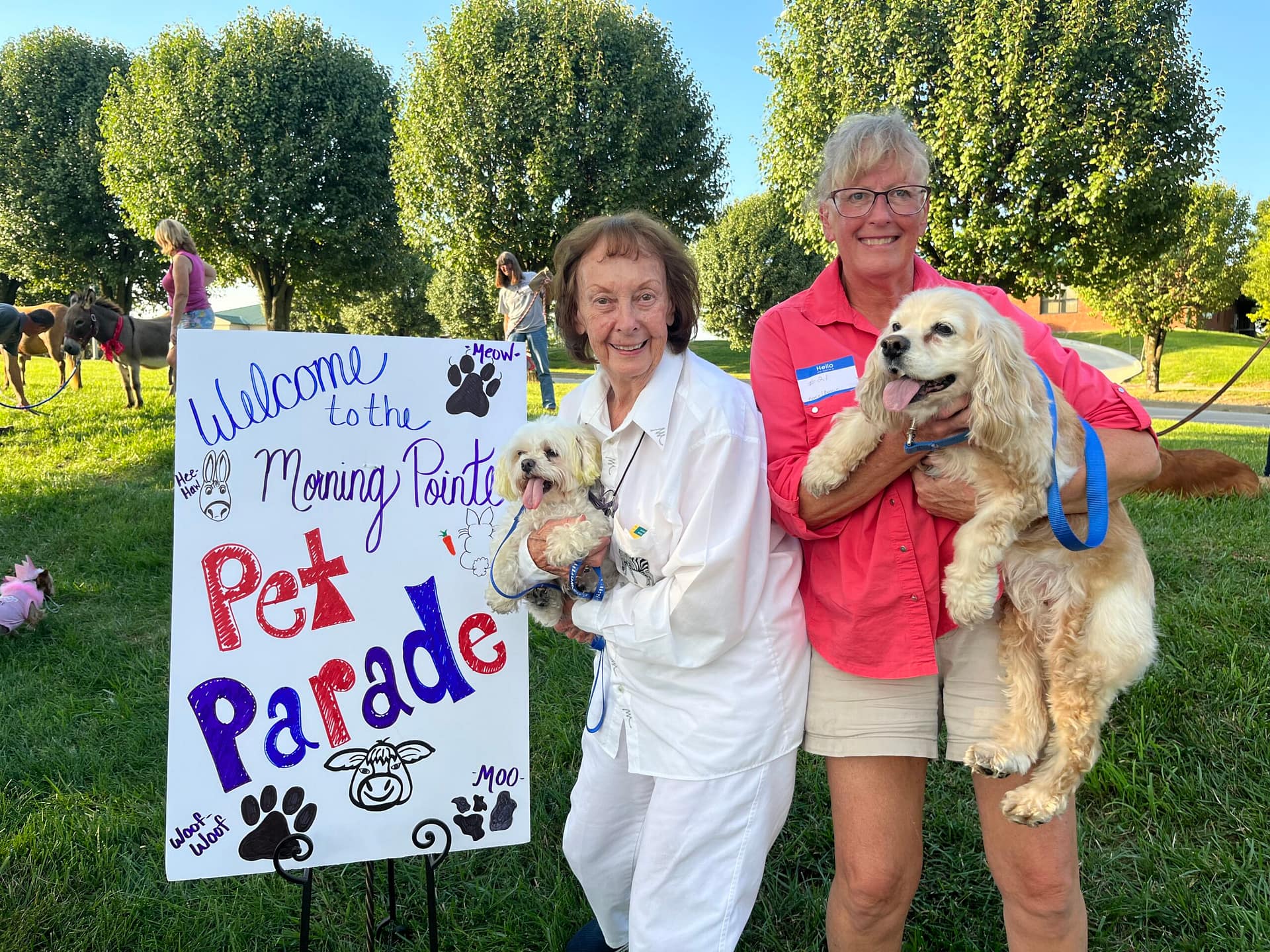 photo of resident Carol Papp with her daughter, Patty Belt, and grand-dogs: Bennie, a Maltese, and Annie, a Cocker Spaniel