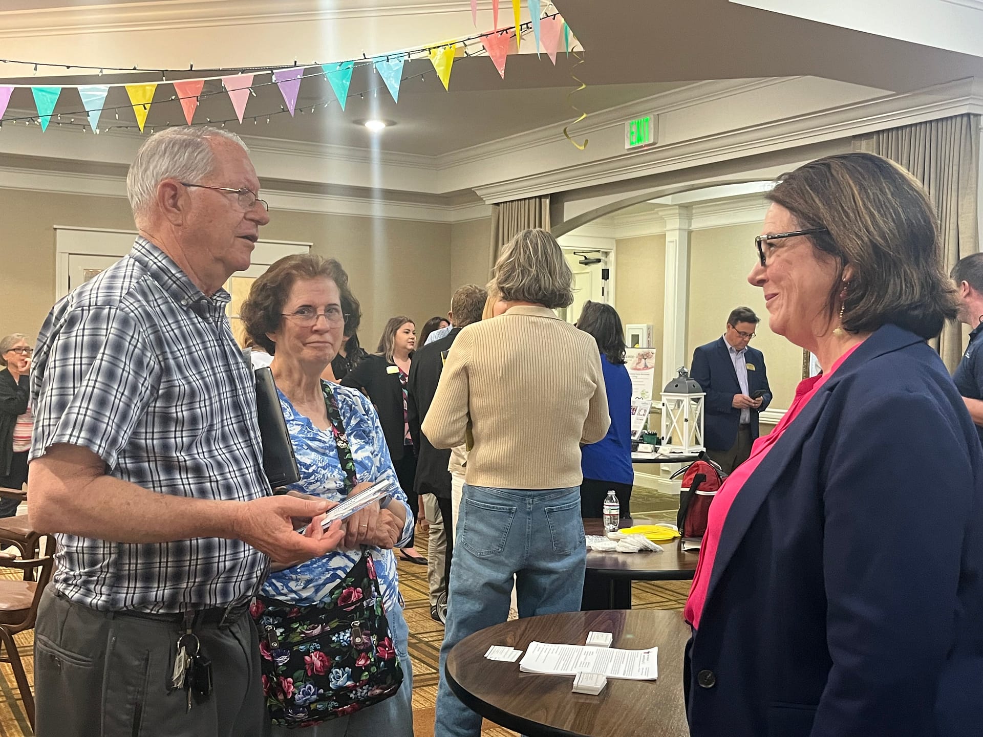 photo of guests talking with Nancy A. Cogar, Esq., elder law attorney with Samples Jennings Clem and Fields, PLLC