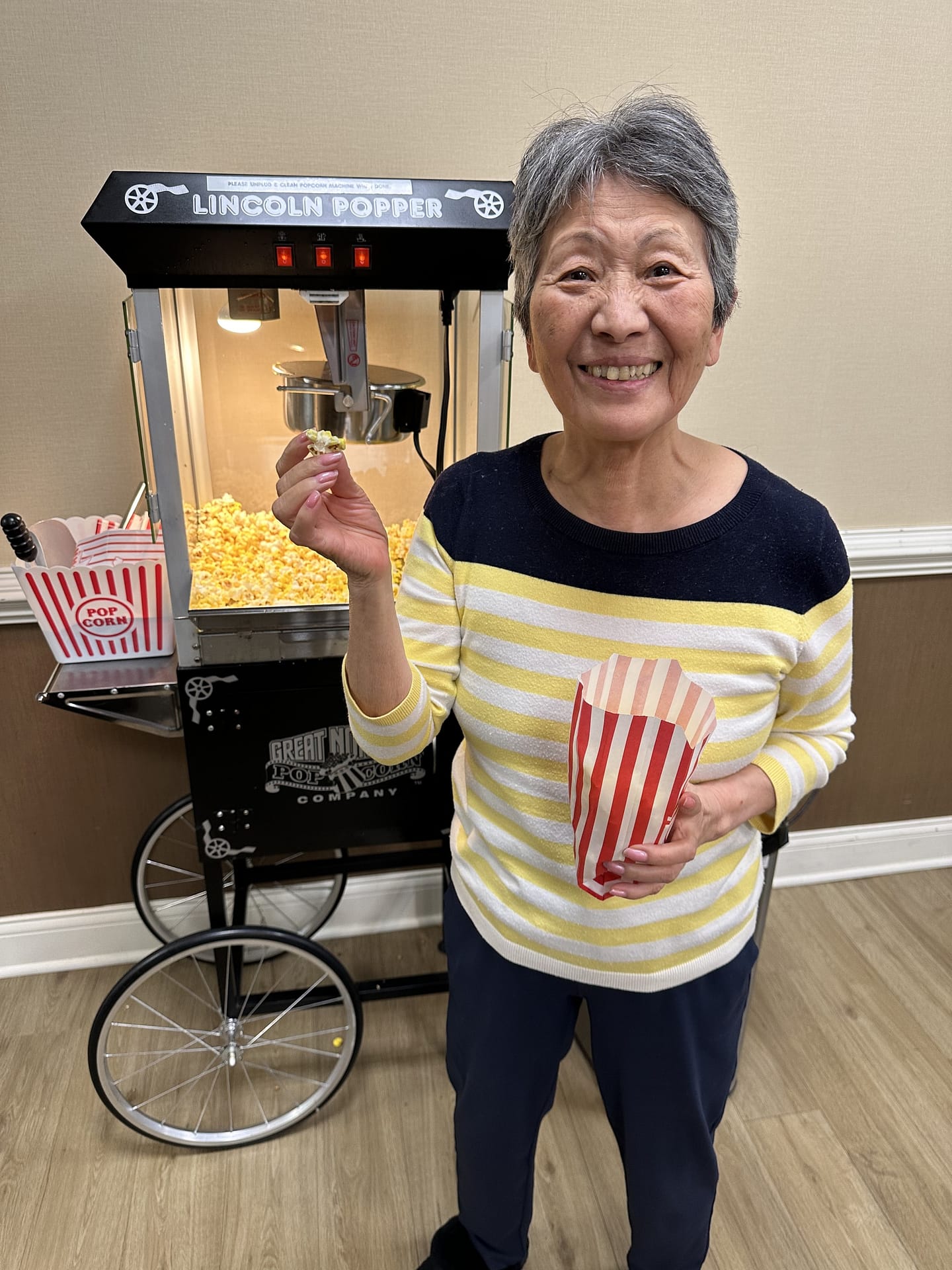 photo of resident at Morning Pointe of Franklin with popcorn