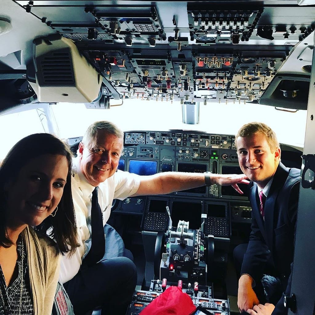 photo of Steve Campbell and his children in an airplane cockpit