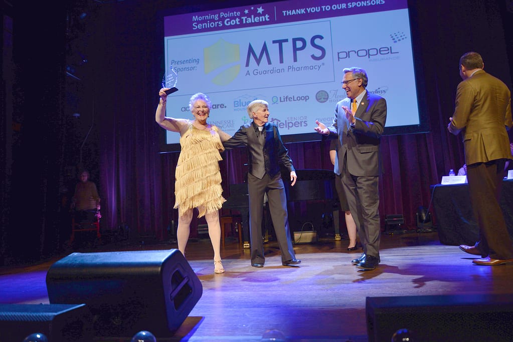 photo of Nancy Stuenkel and Lane Wilkinson celebrating winning the Franklin, TN, show in 2022, with Greg A. Vital, Morning Pointe Co-Founder and President