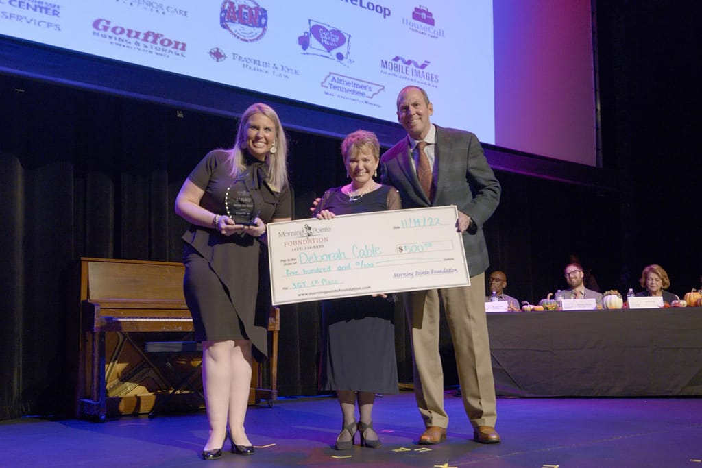 photo of Deborah's grand prize, with Miranda Perez, Executive Director of the Morning Pointe Foundation, and Franklin Farrow, Morning Pointe Senior Living Co-Founder and CEO