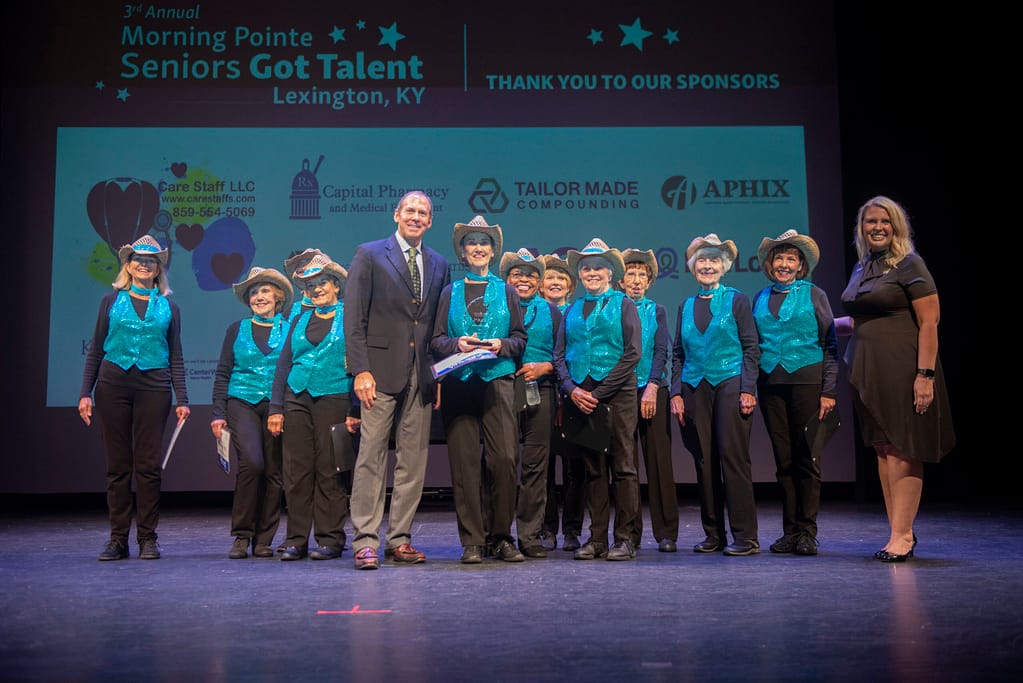 photo of Franklin Farrow, Morning Pointe Senior Living Co-founder and CEO, with the Flat Out Fun Dance Team, second-place winners; and Miranda Perez, Morning Pointe Foundation Executive Director