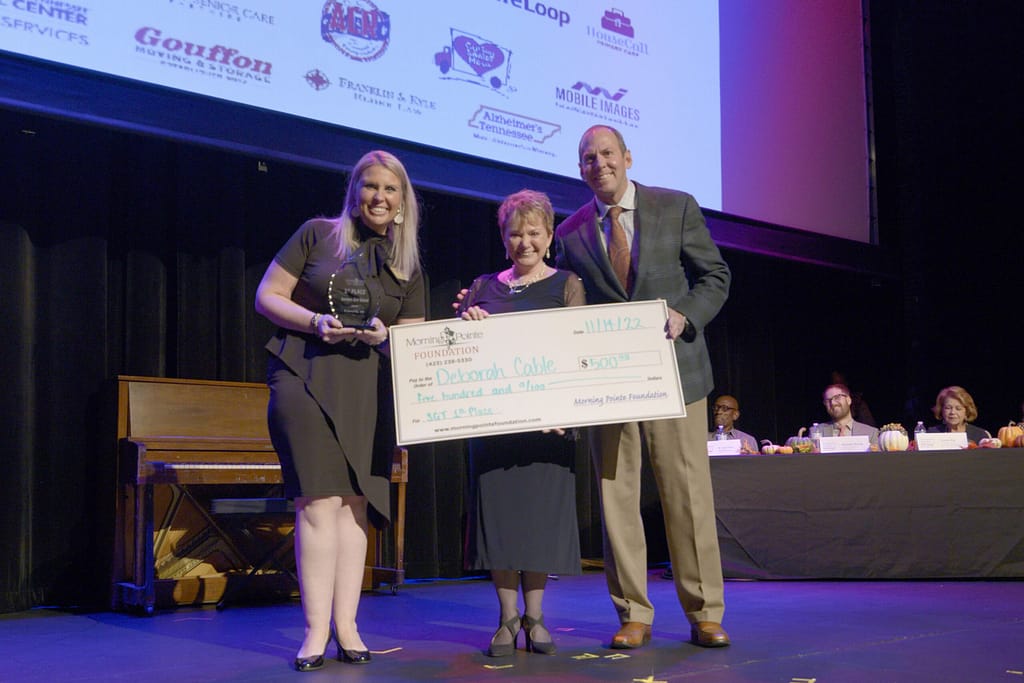 photo, left to right: Miranda Perez, Executive Director of the Morning Pointe Foundation; Deborah Cable, grand-prize winner; and Franklin Farrow, Morning Pointe Senior Living Co-Founder and CEO