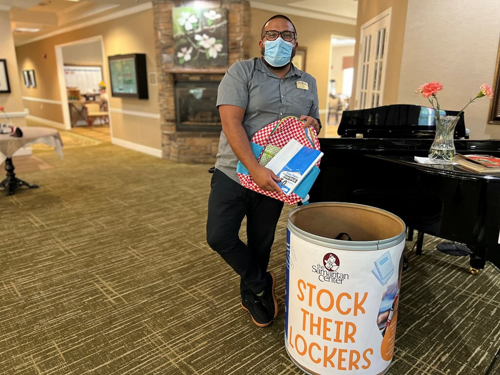 photo of Ian Shives, executive director at Morning Pointe of Collegedale at Greenbriar Cove, with school supplies