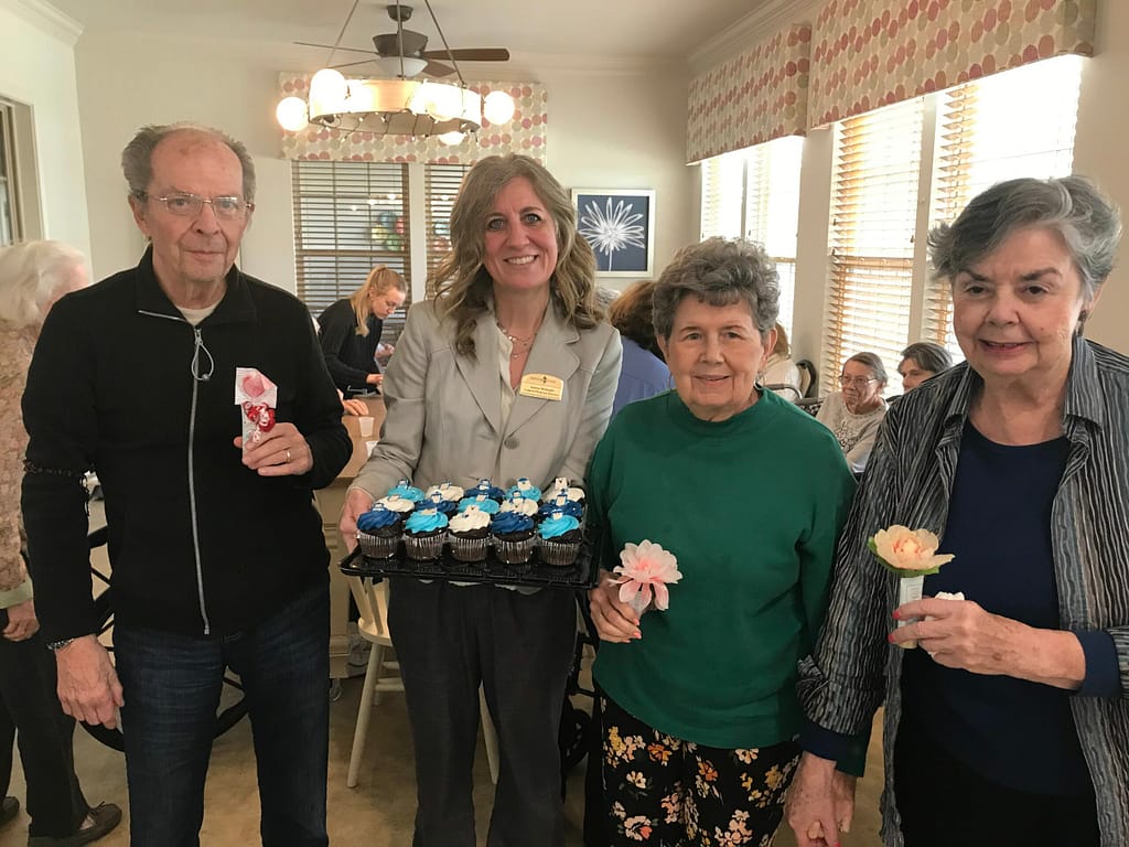 photo of Audrea with residents at a monthly birthday party