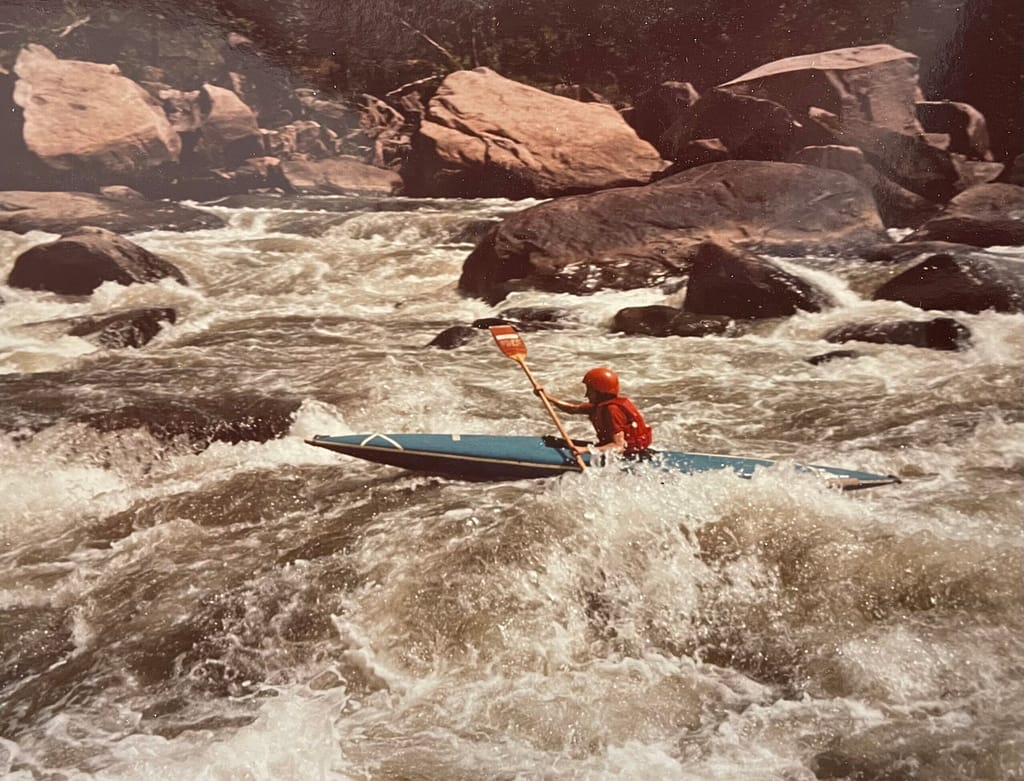 photo of Nancy kayaking a rapid