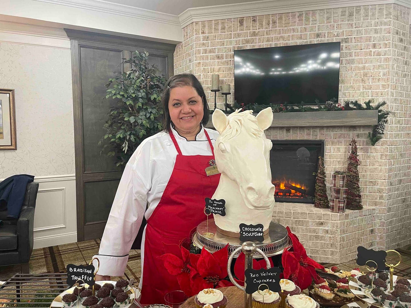 photo of Ellen Vitorino, Food Services Director, with her white chocolate horse sculpture