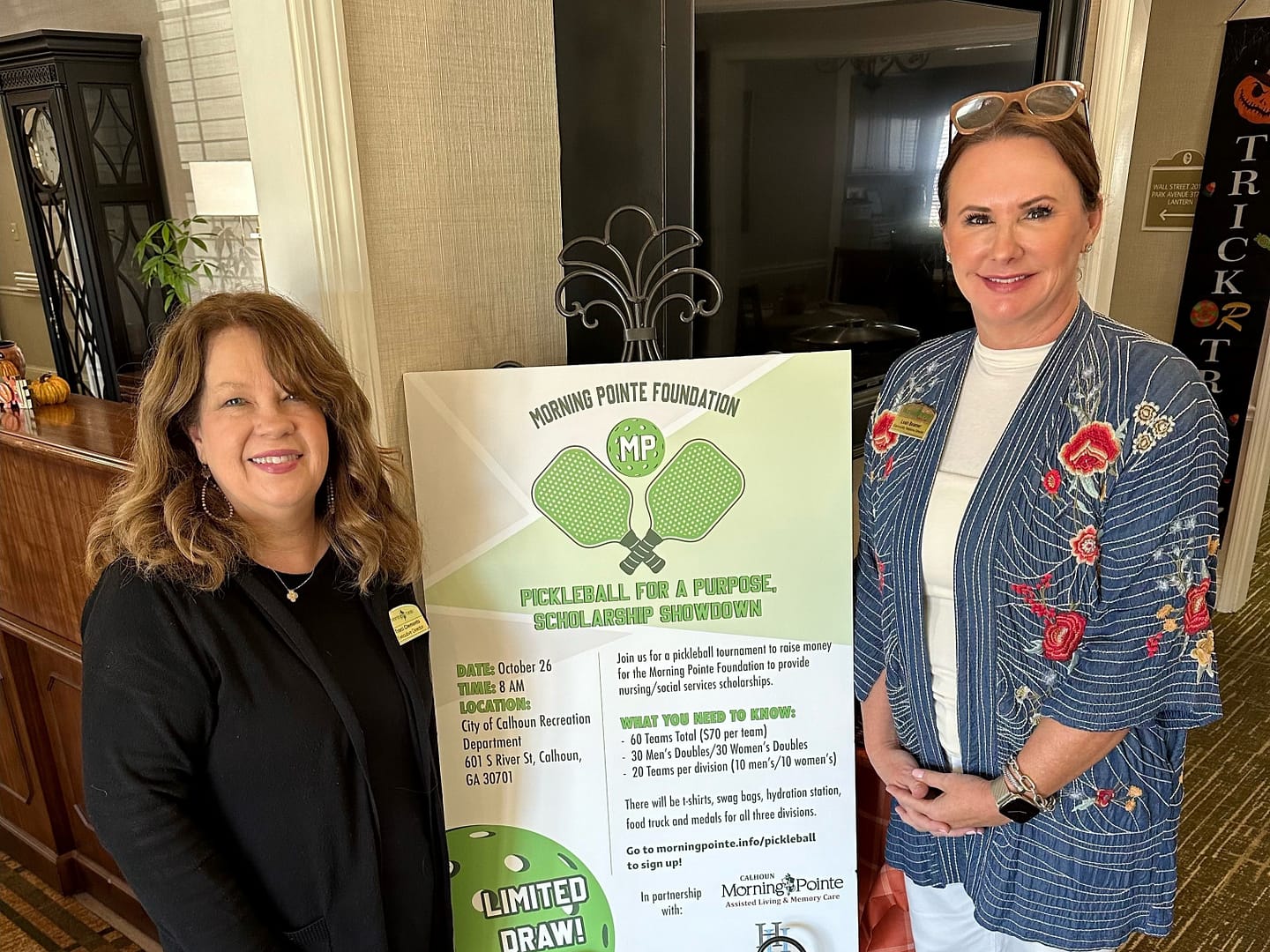 Photo of Traci Clements, executive director at Morning Pointe of Calhoun, and Leah Beamer, community relations director, with the pickleball poster