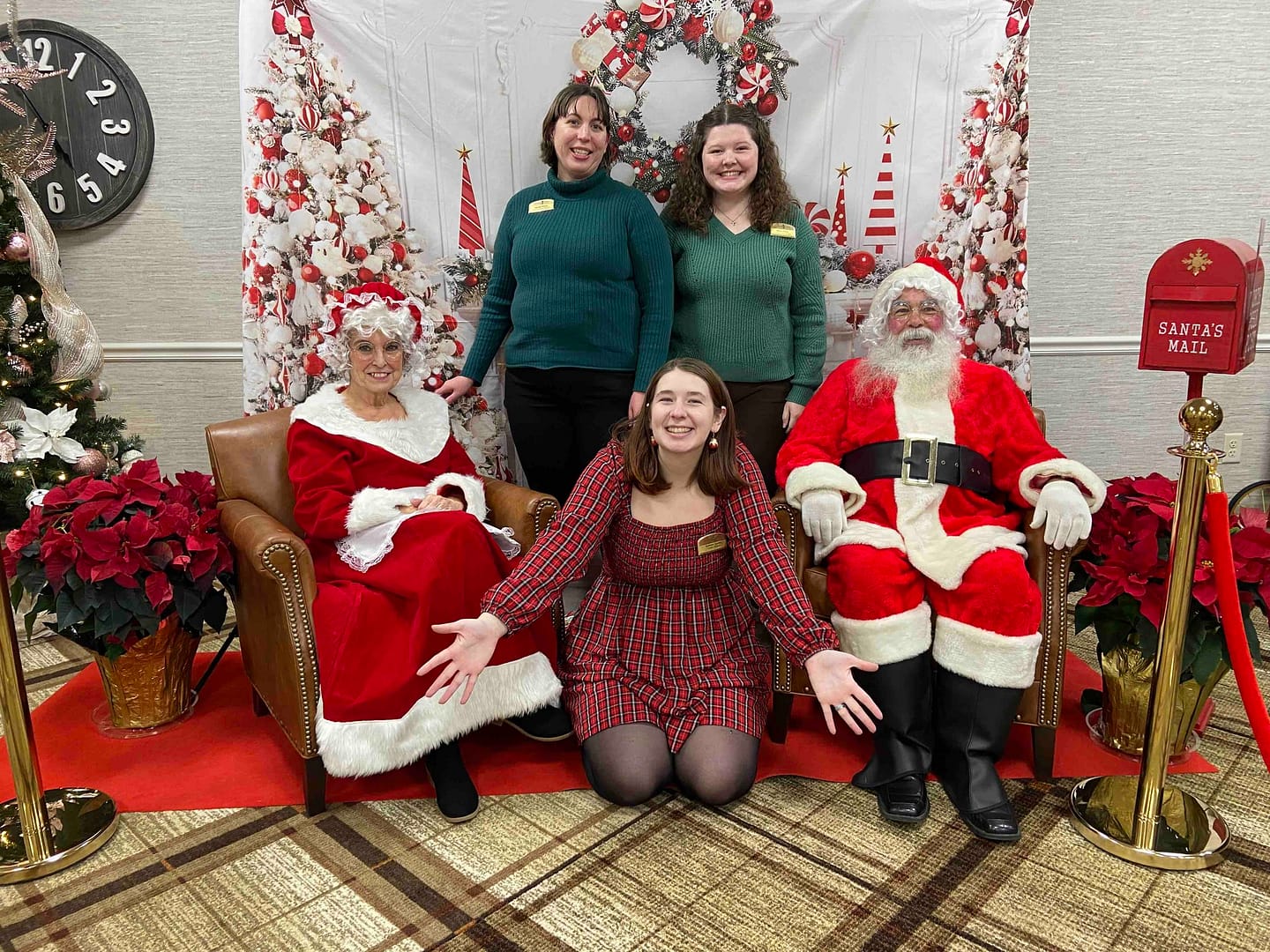 photo of Morning Pointe Senior Living Communications Department members Heidi Pino, Renee Tatum, and Summer Locke, with Santa and Mrs. Claus