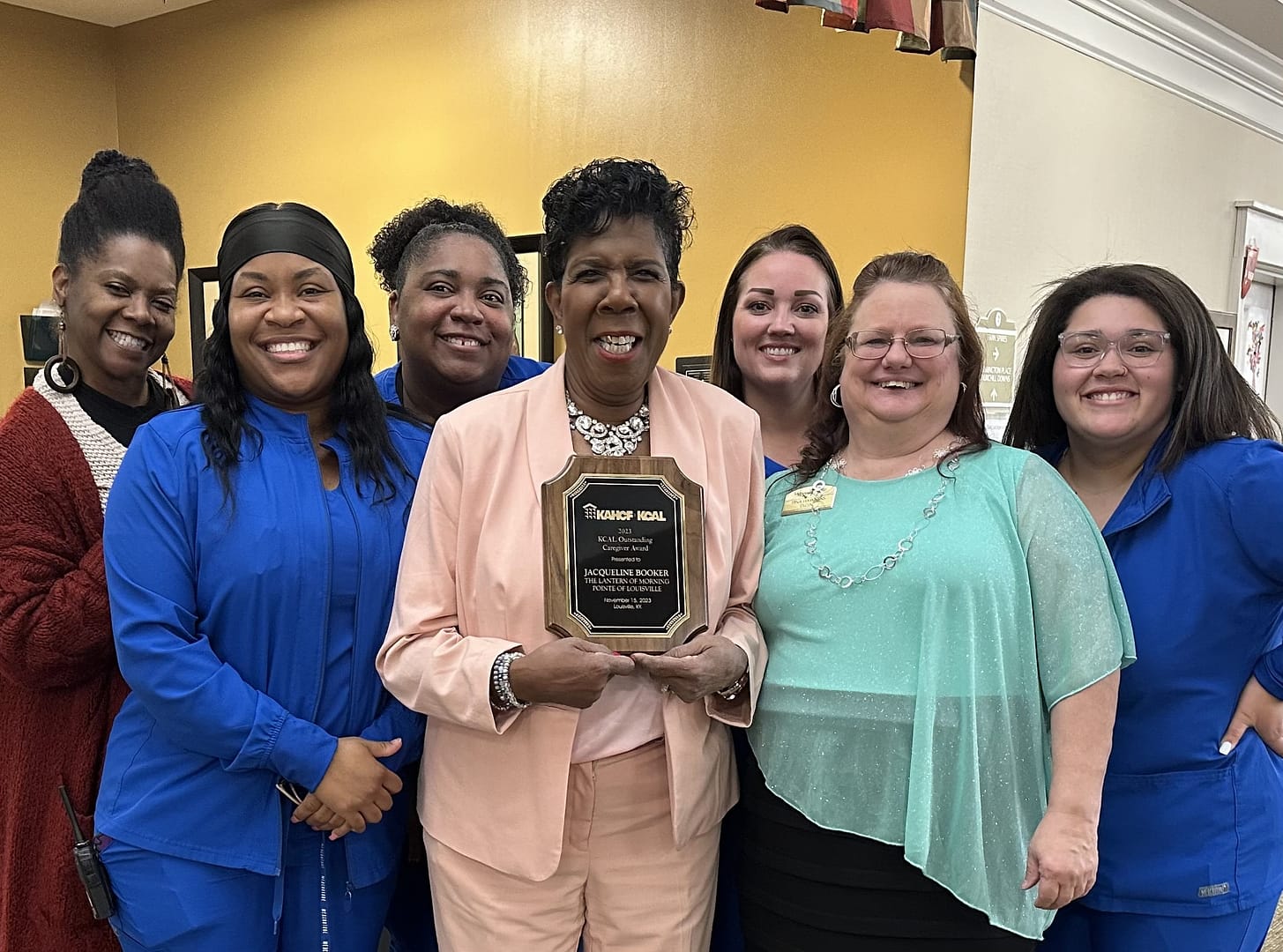 Jackie Booker, center, Lantern Program Assistant at The Lantern at Morning Pointe of Louisville, and winner of the Outstanding Caregiver Award