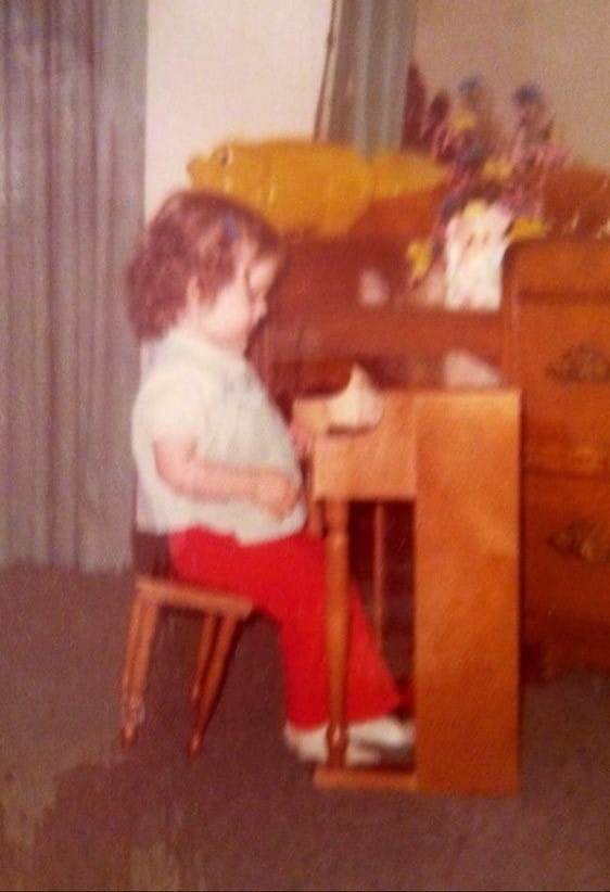 photo of Kathy Tarter as a child at her piano