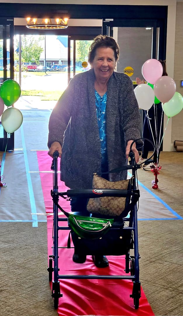 Photo of One of Morning Pointe of Danville Assisted Living's first residents walking down the red carpet