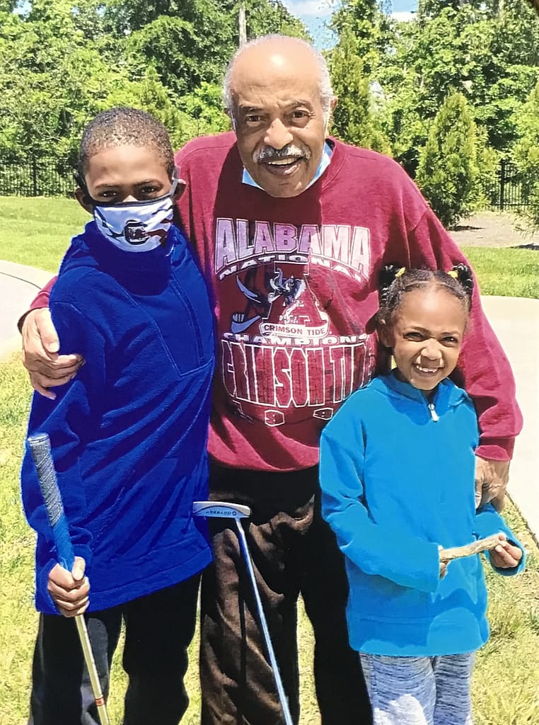photo of Richard with his two step-grandchildren