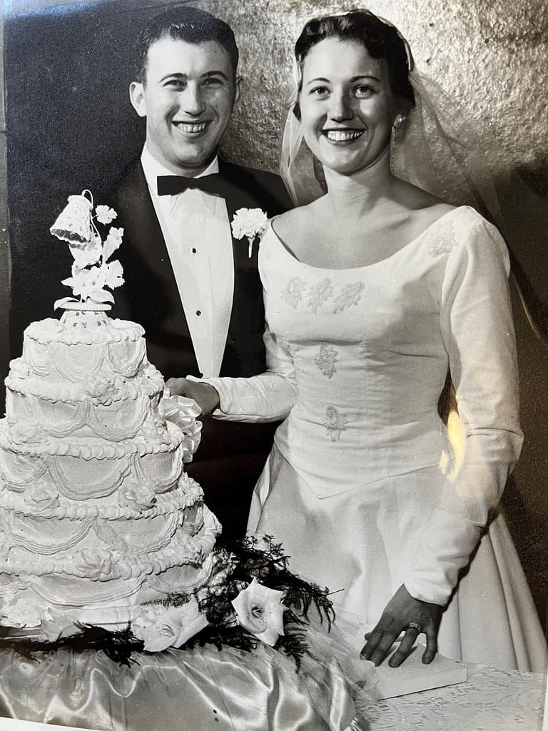 photo of Ann and Harry with their wedding cake