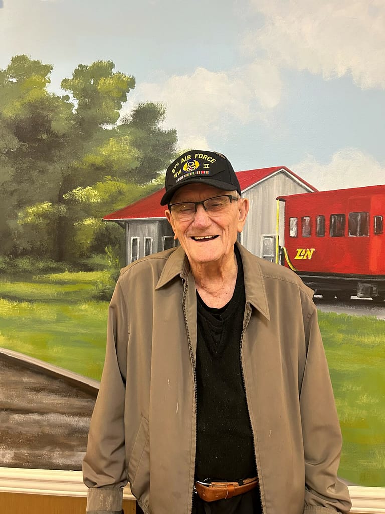 photo of Claude with the L&N mural at Morning Pointe
