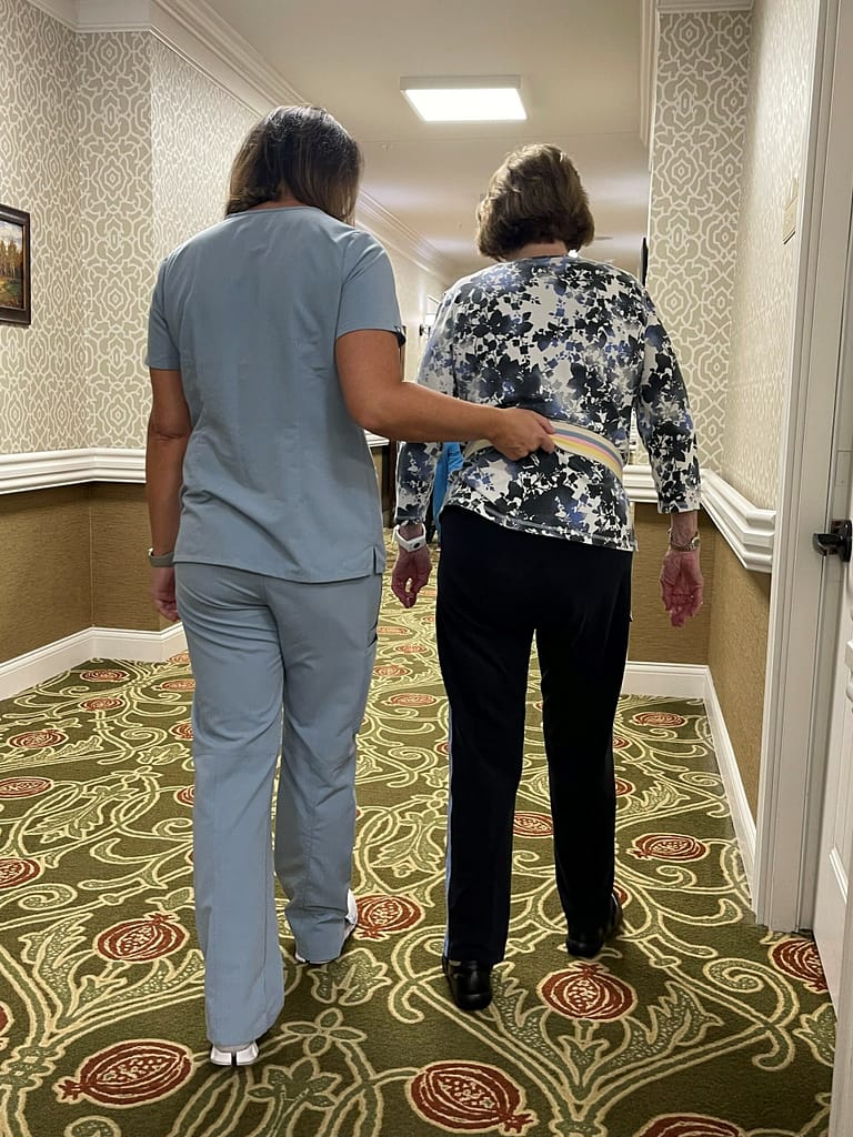photo of therapist walking with resident