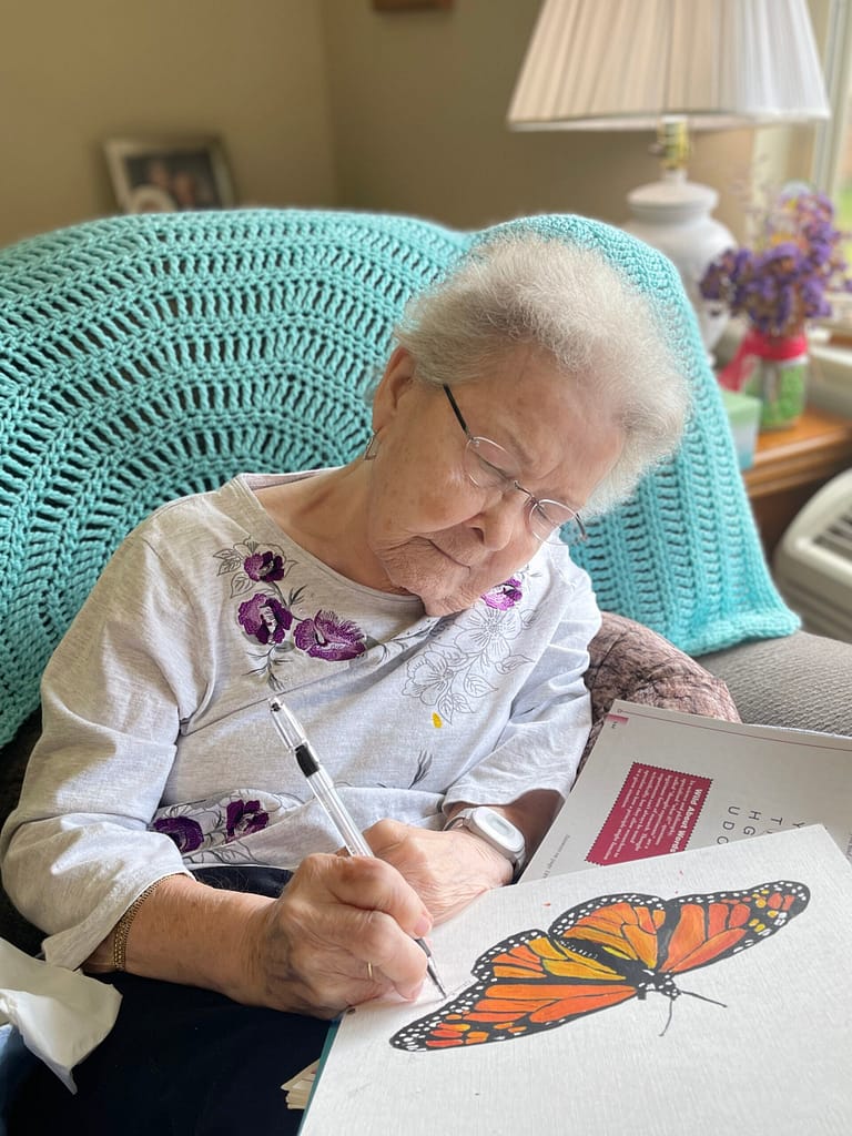 photo of Eileen Beattie with her monarch artwork