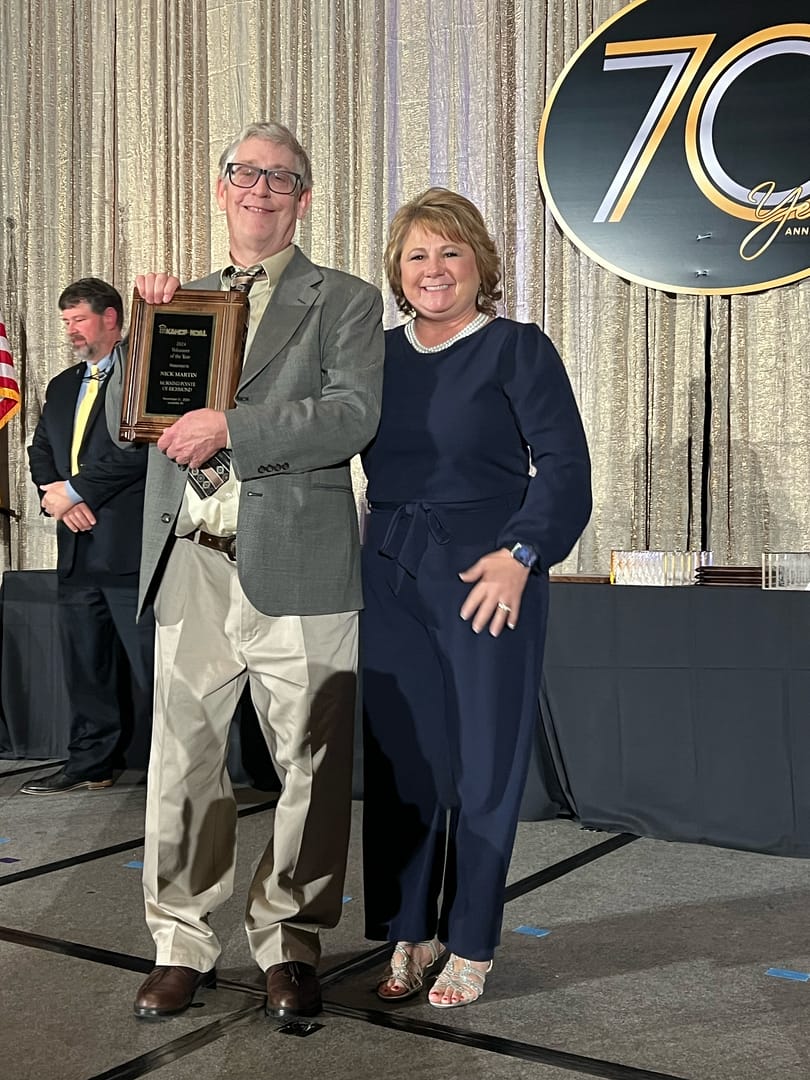 photo of Nick Martin with Cristy Winkler, executive director, receiving his award