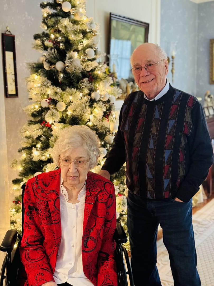 photo of Linda and Bert Hahn in front of Bert's Christmas tree