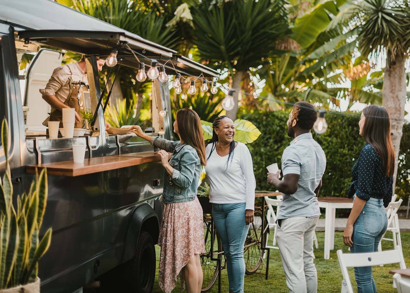 Food truck with a group of people around it